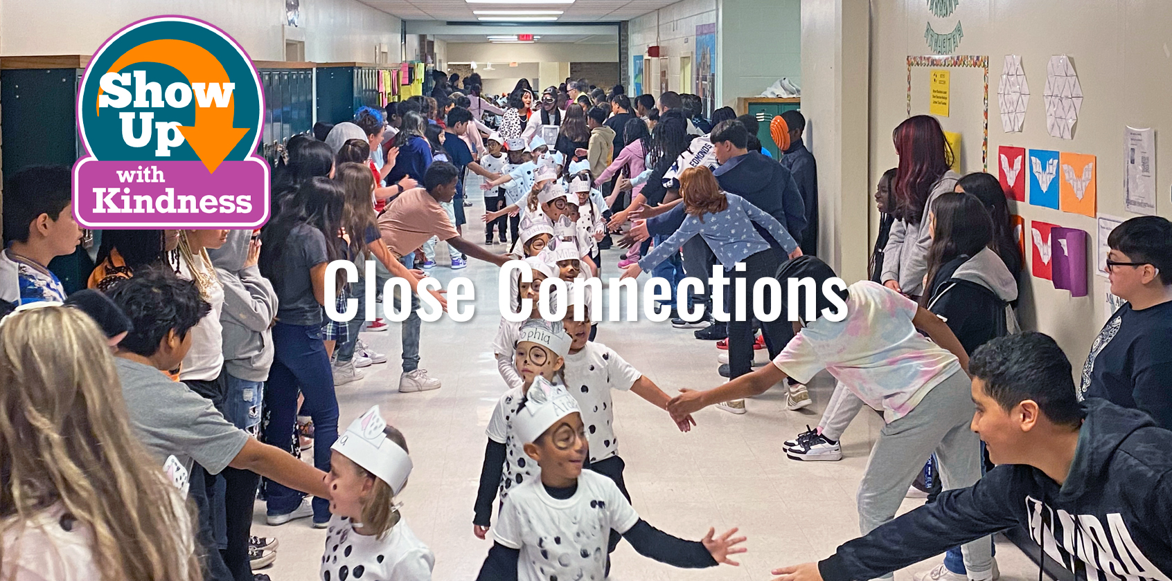 Close connections written on photo. Kids in hallway parading through older students high fiving them.