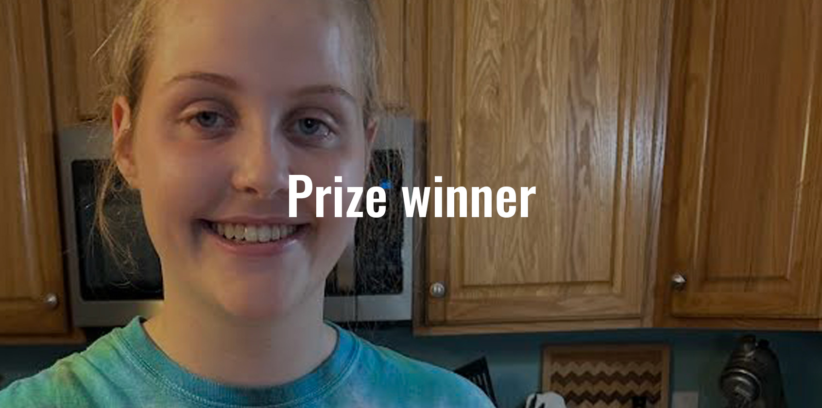 A Bird High School student is smiling in her kitchen