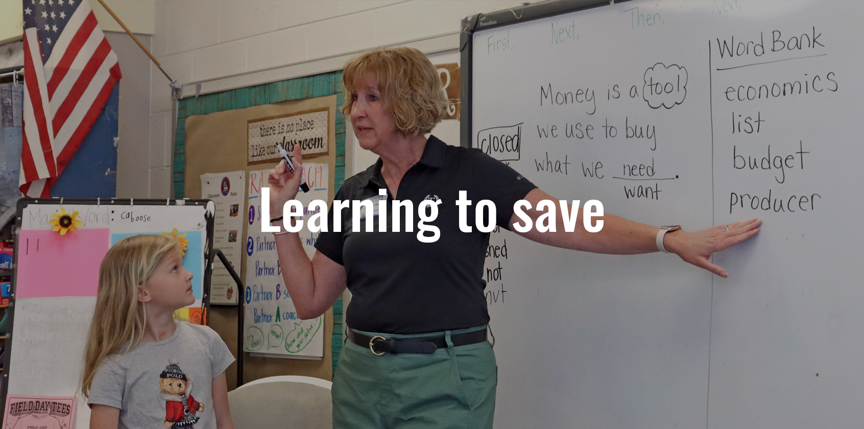 A TowneBank educator is pointing at the whiteboard
