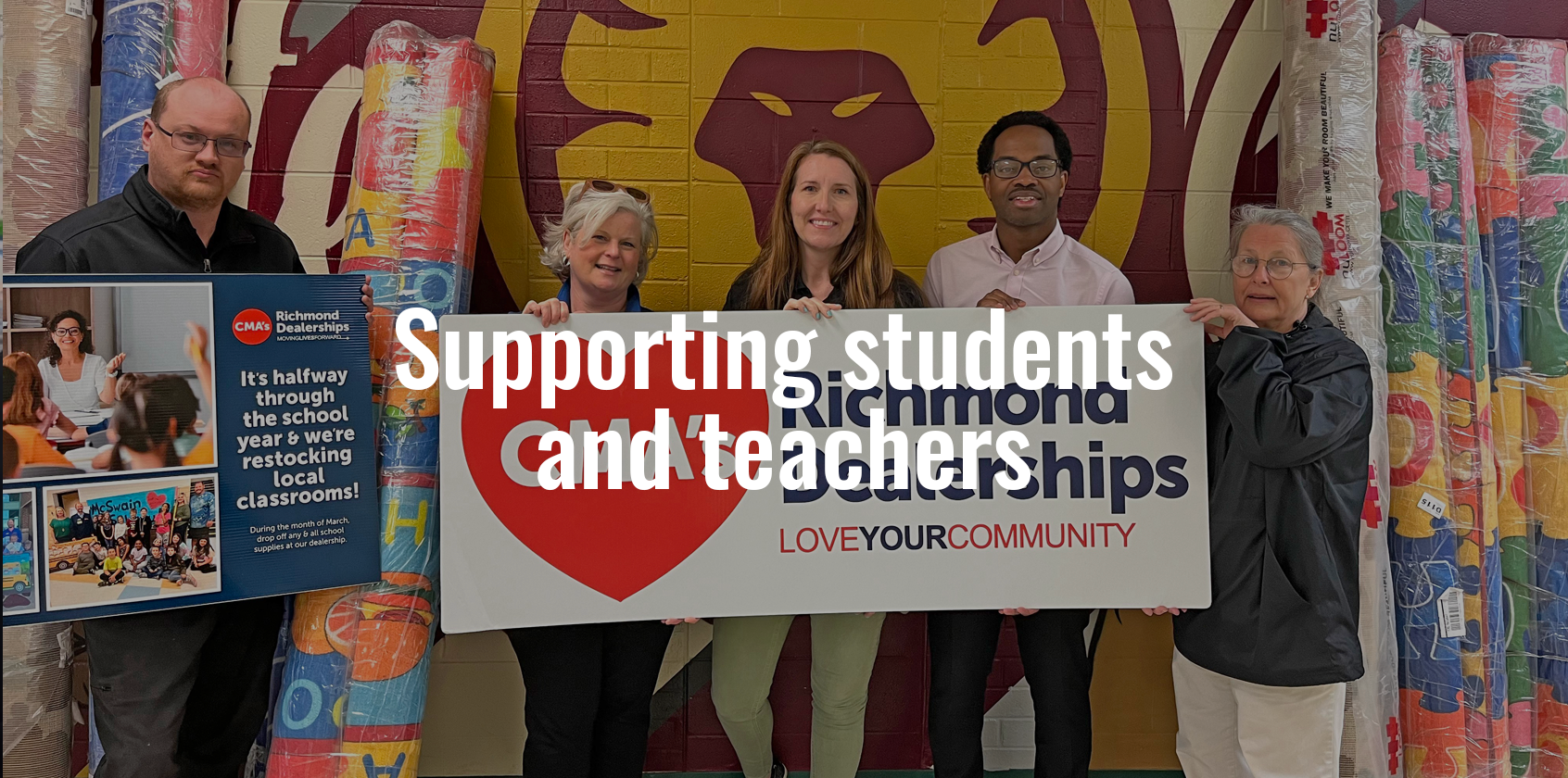 Four adults holding up a CMA Richmond Dealership sign.