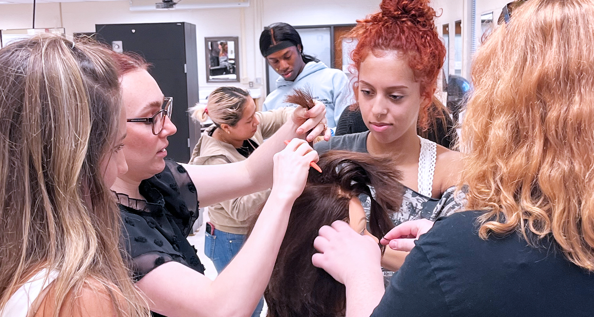 Several students working on hair in hair salon at the CTC@Hull