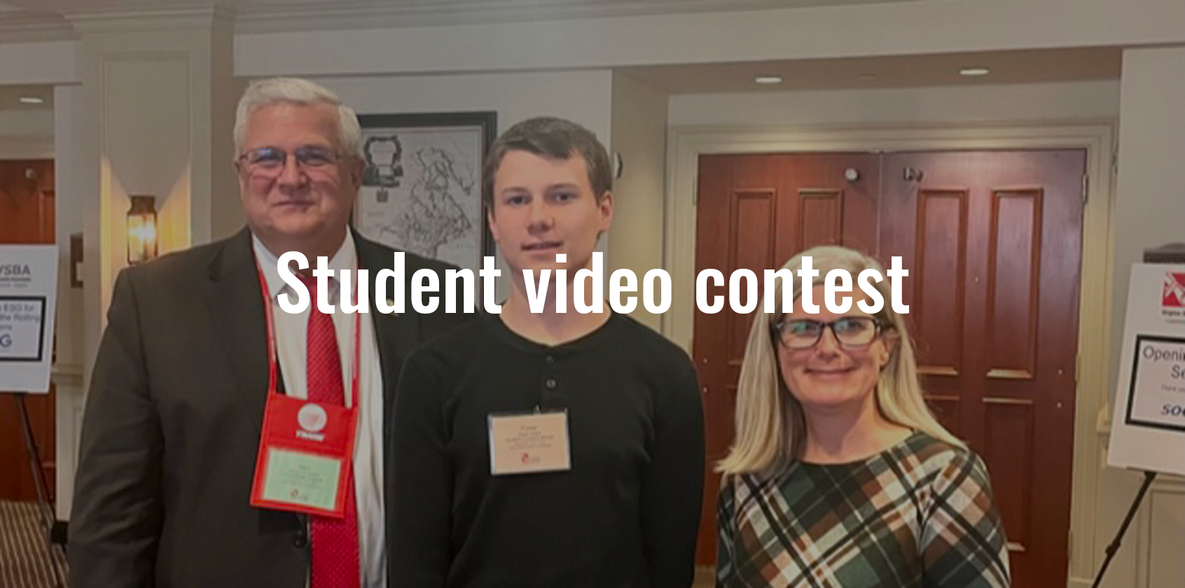 Superintendent, a student and a school board member pose for a photo, text says "Student video contest"