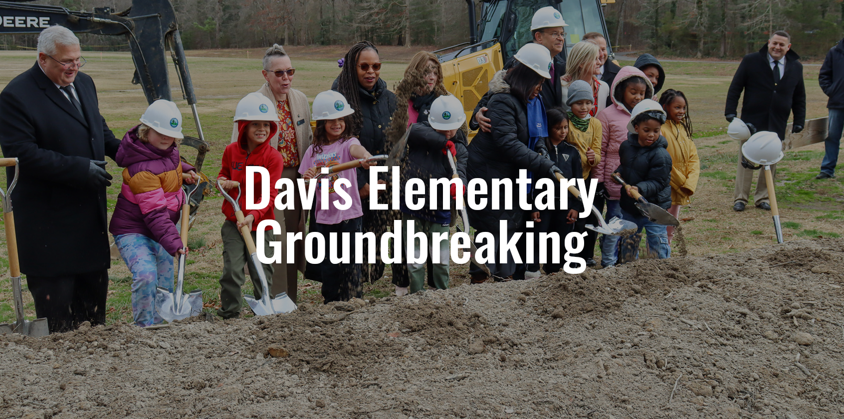 Students shoveling dirt and text that says "Davis Elementary Groundbreaking"