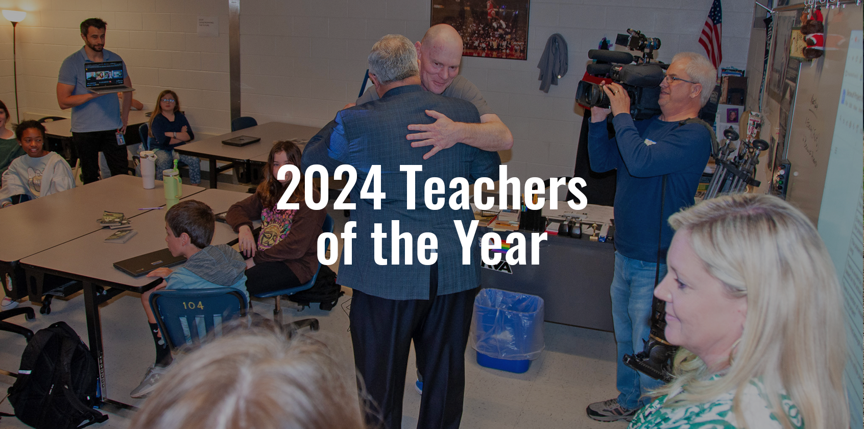 Teacher of the year hugging the Superintendent with text that says "2024 Teachers of the Year"