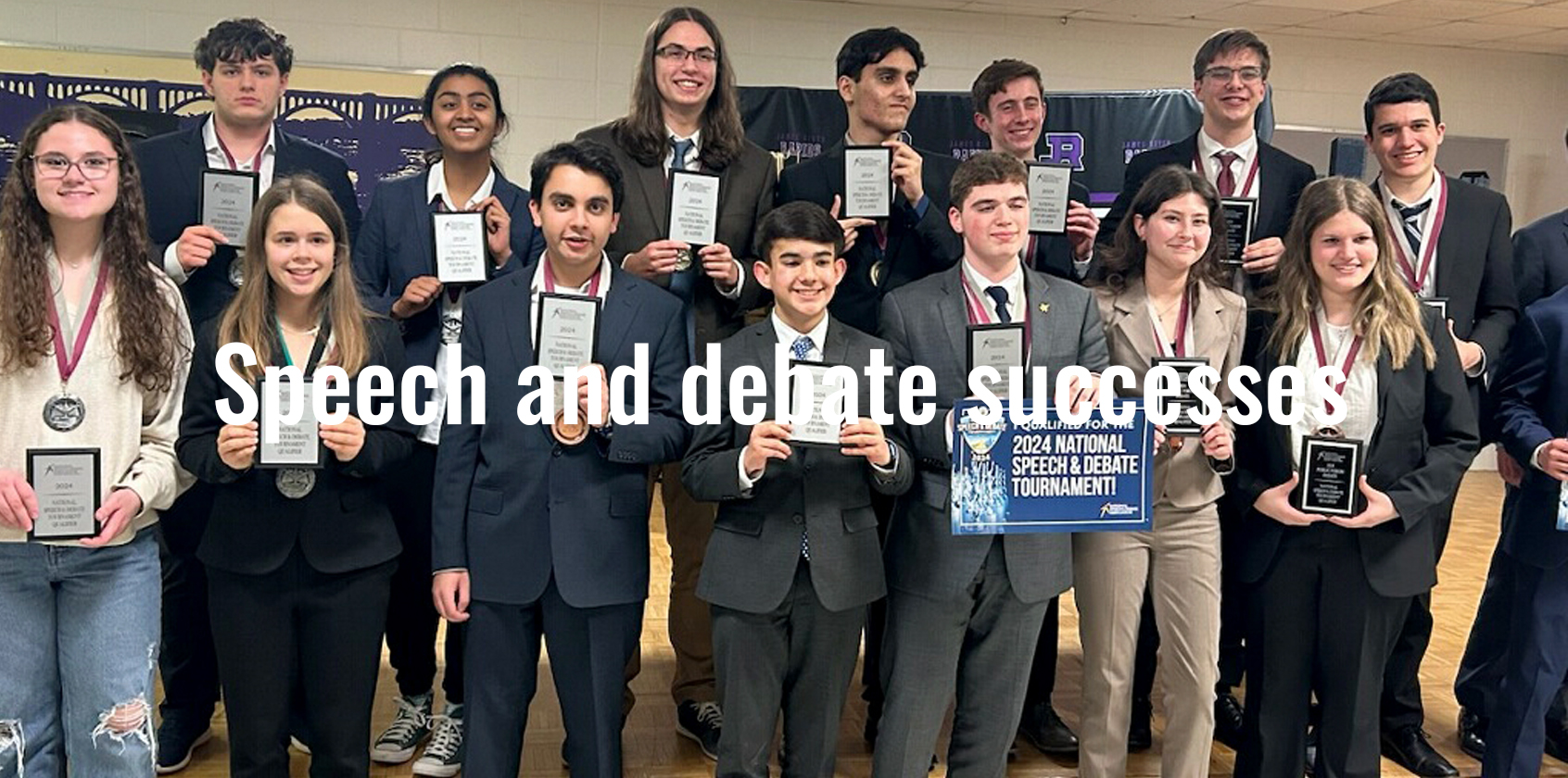 Students pose for a group photo holding their awards