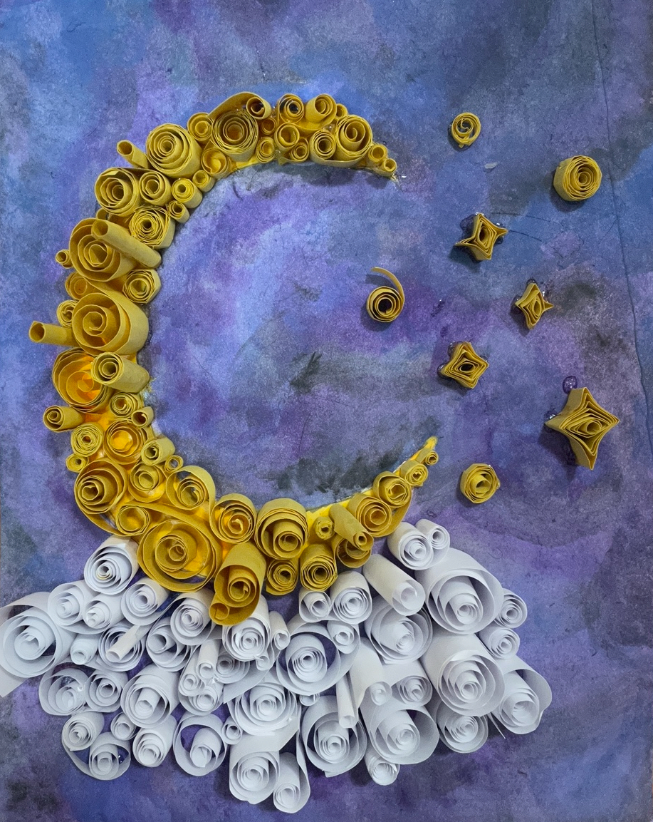 Artwork of a crescent moon made of construction paper