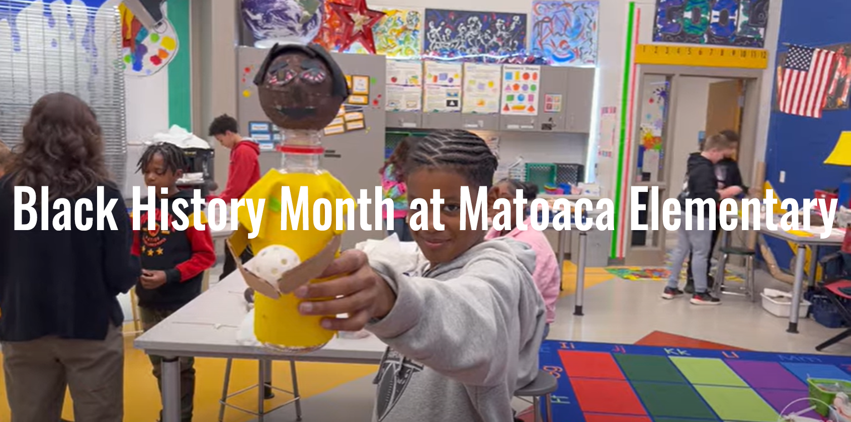 Student shows her project for the camera