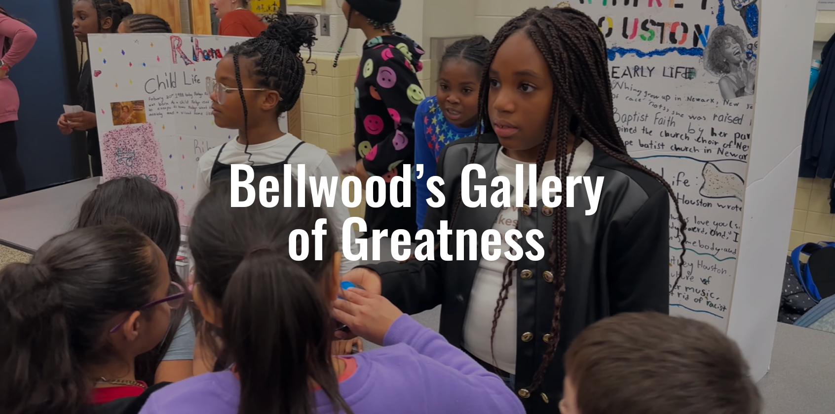 A student standing in front of her poster during a living wax museum