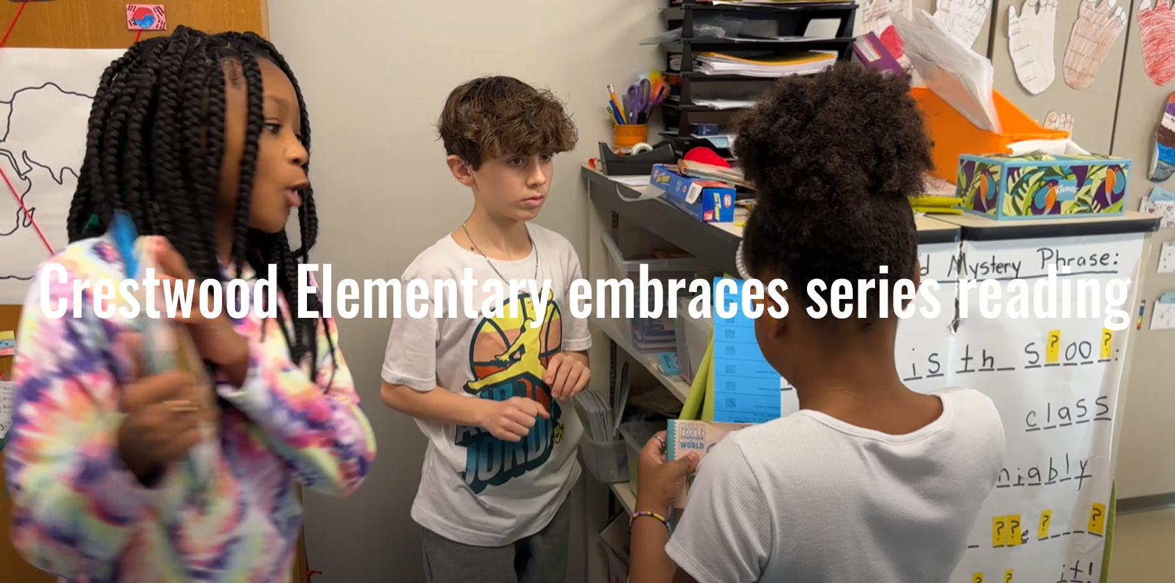 Three students checking out books