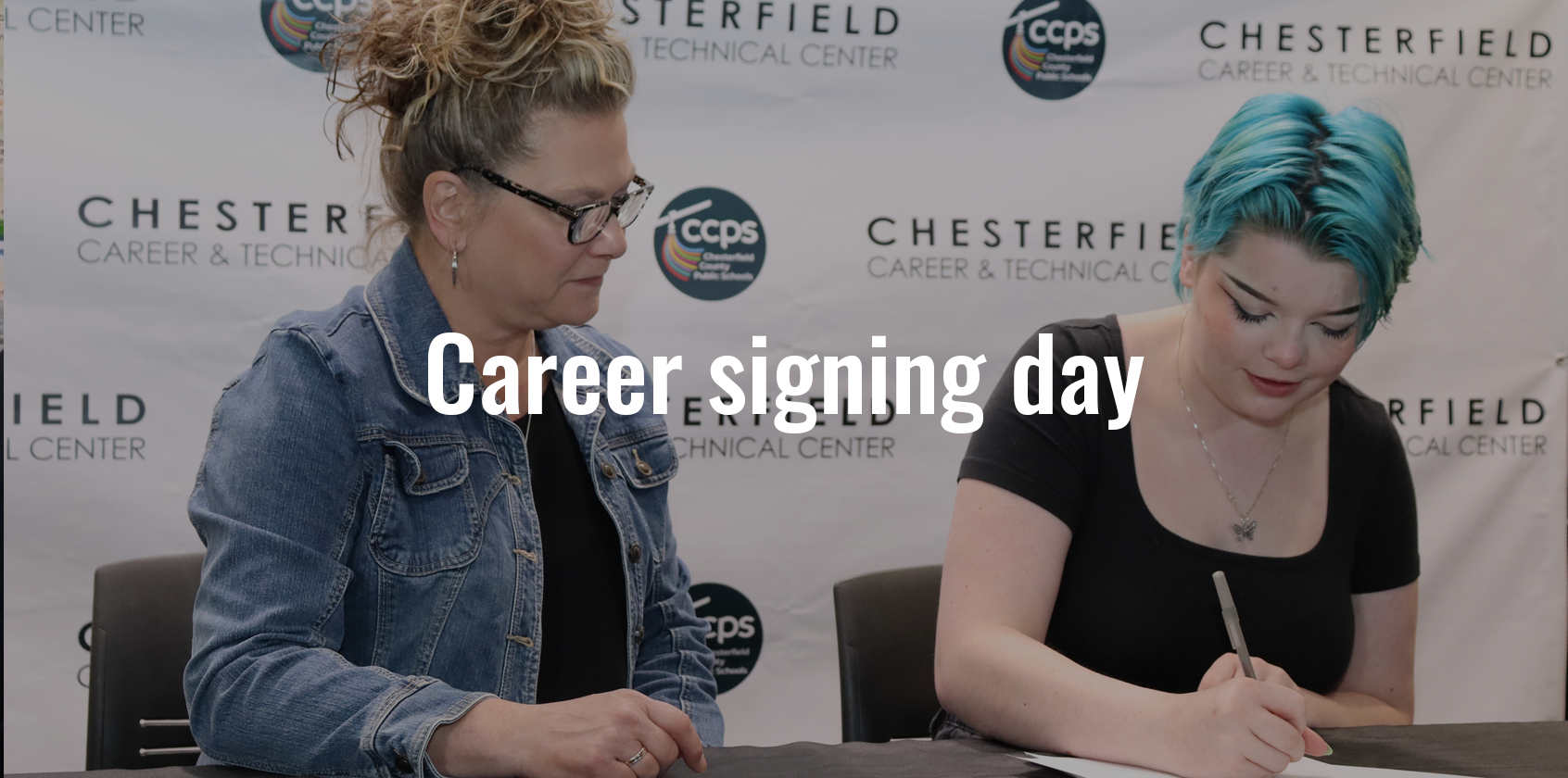 A woman watching a student sign a piece of paper and text that says "Career signing day"