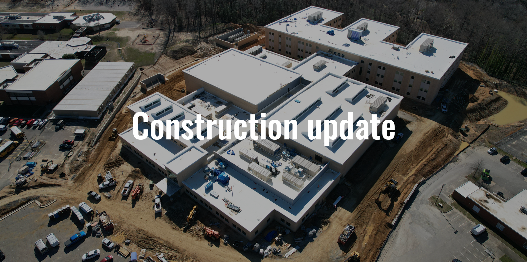 Aerial image of a new school with text that says "Construction update"