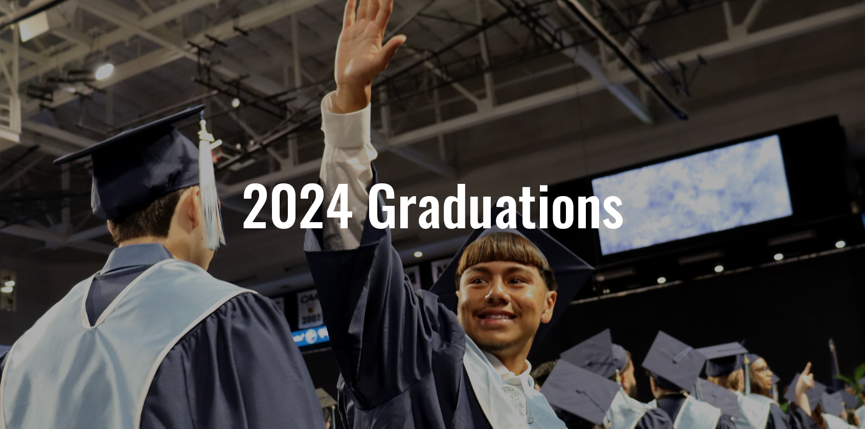 A student waving during his graduation with text that says "2024 Graduations"