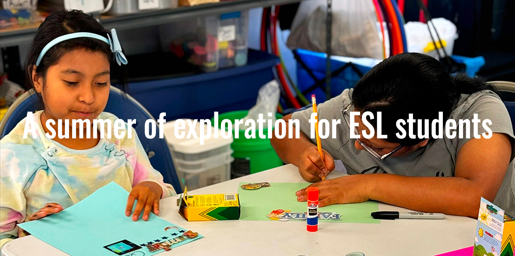 Two students working at their table.