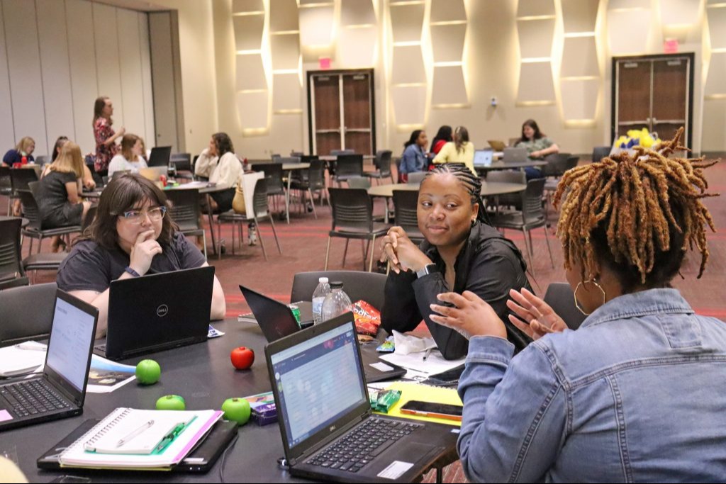 Three professional women collaborating at conference