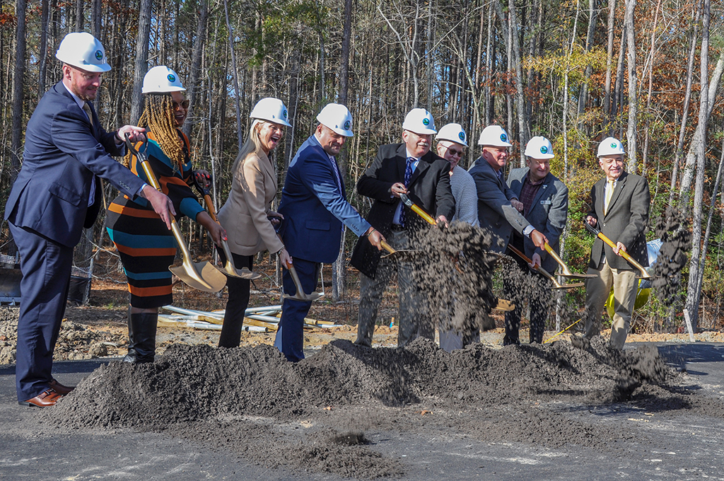 Leadership shoveling dirt at ceremony