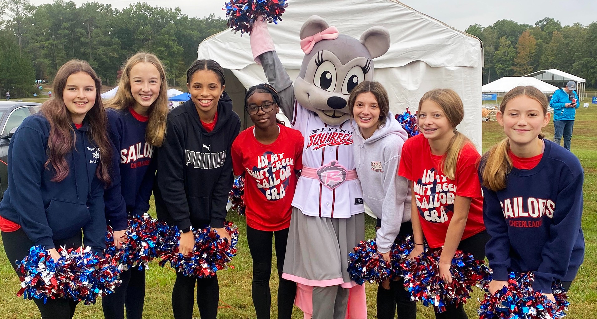 cheerleaders pose with mascot