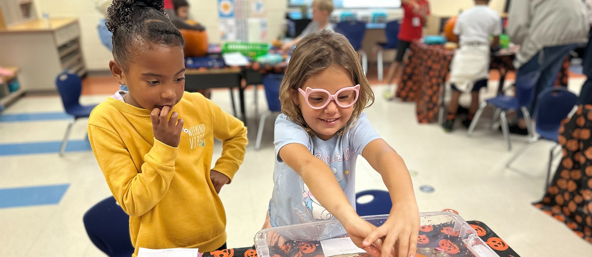 Two young female students working together on a project