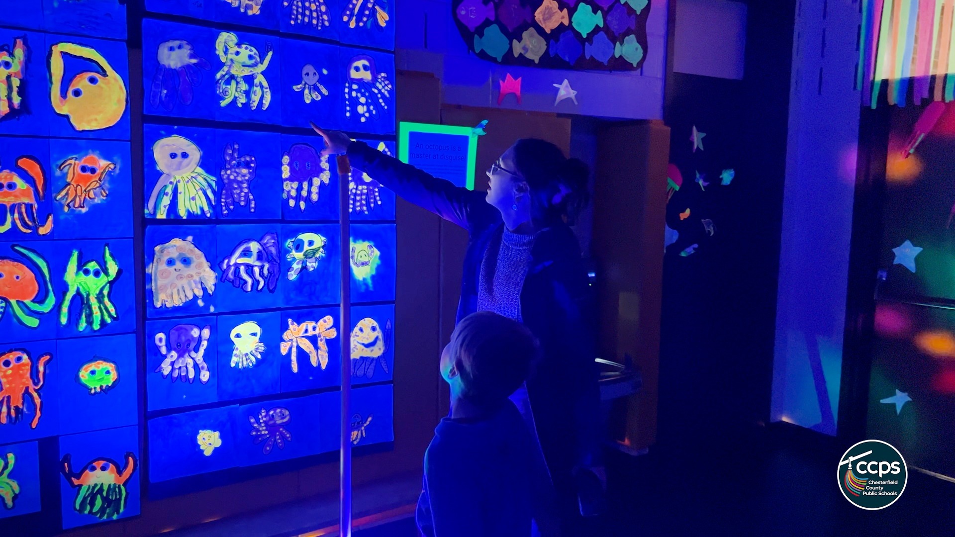 Family looking at glow-in-the-dark art