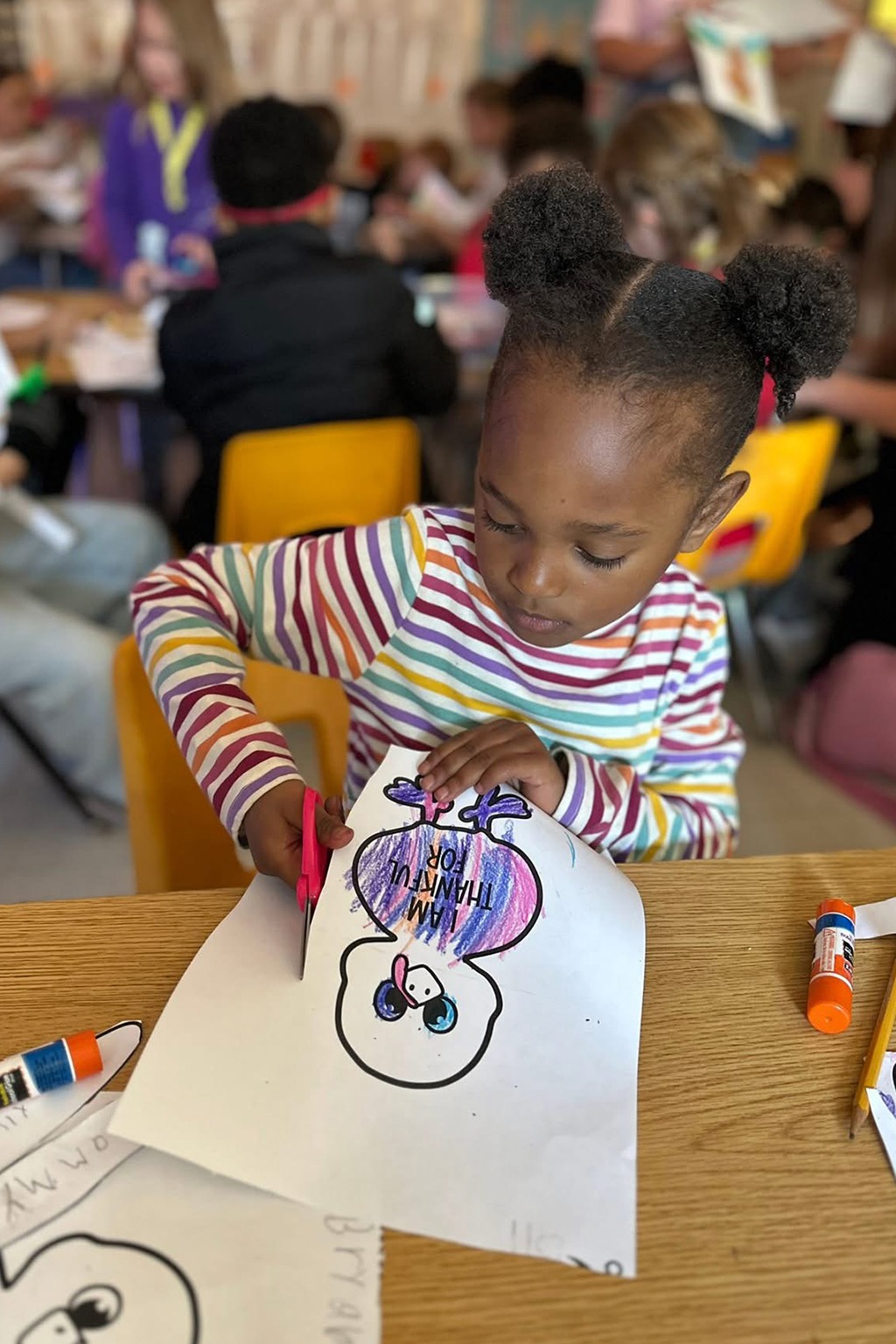 student cutting with scissors