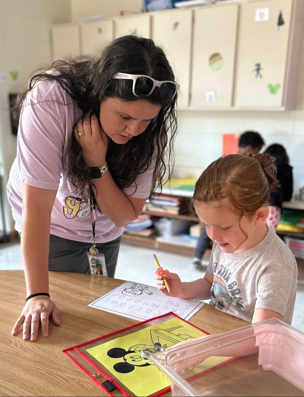 teacher helping student