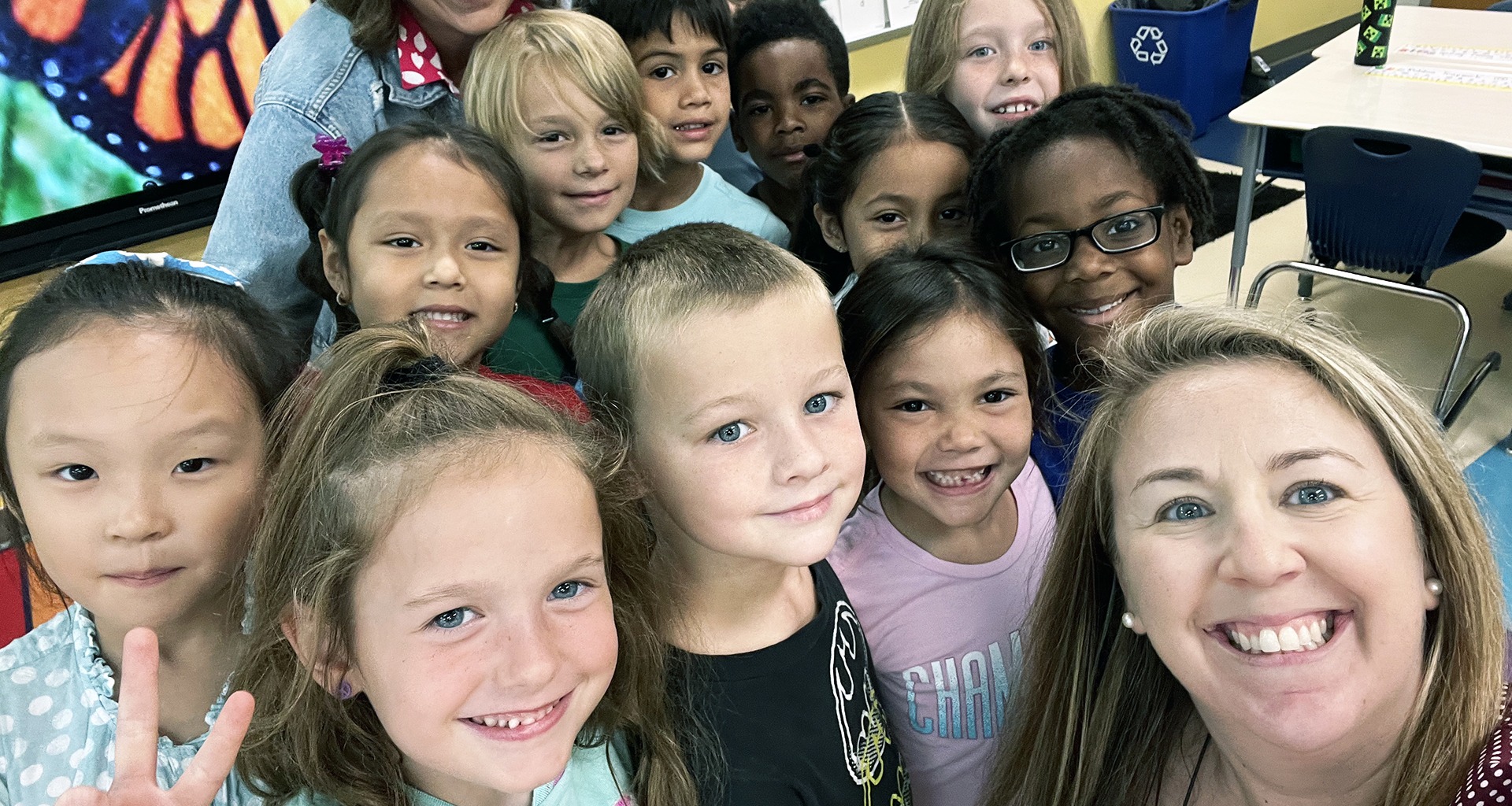 teacher takes selfie with class