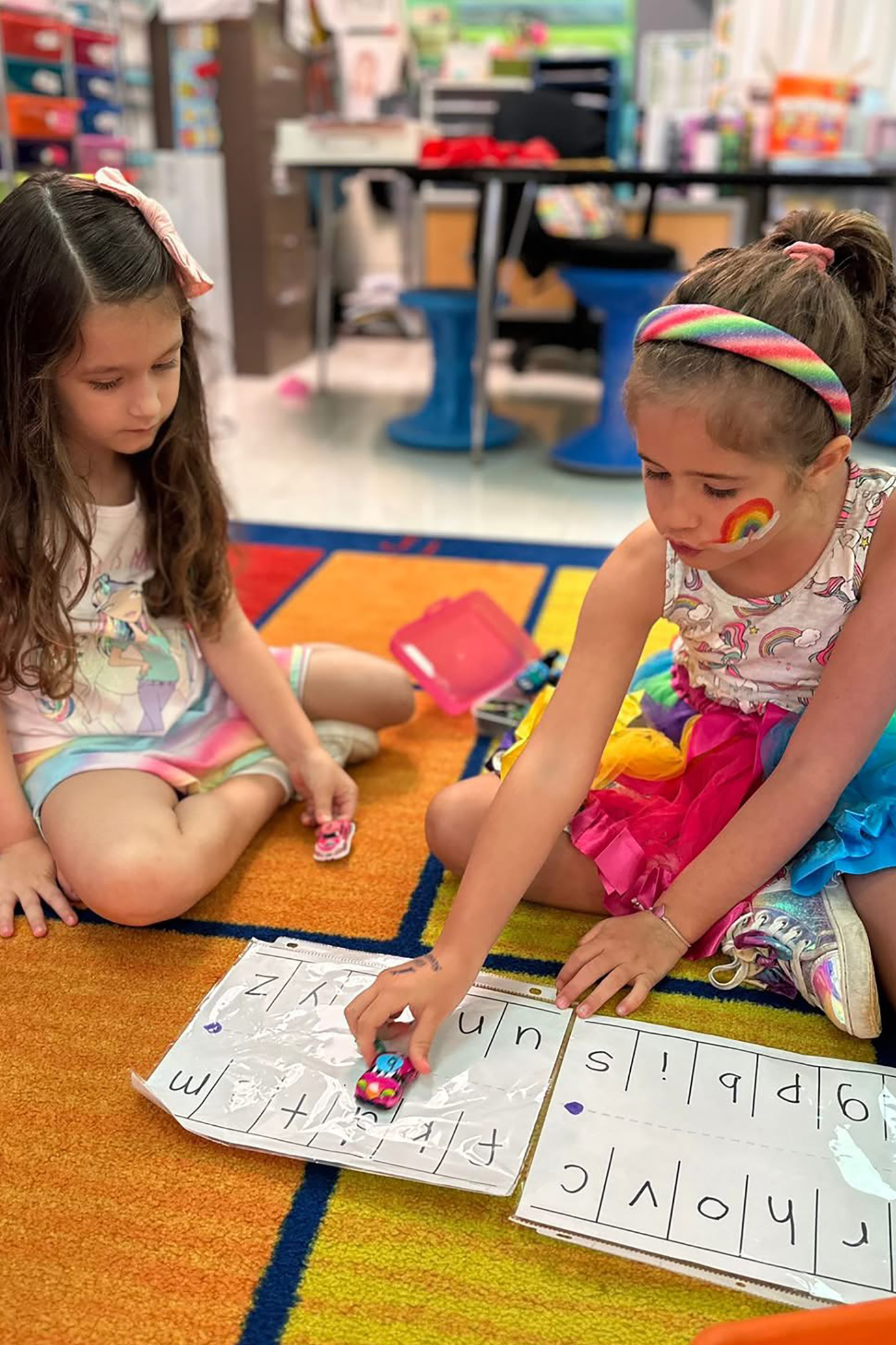 two girls working together on the floor