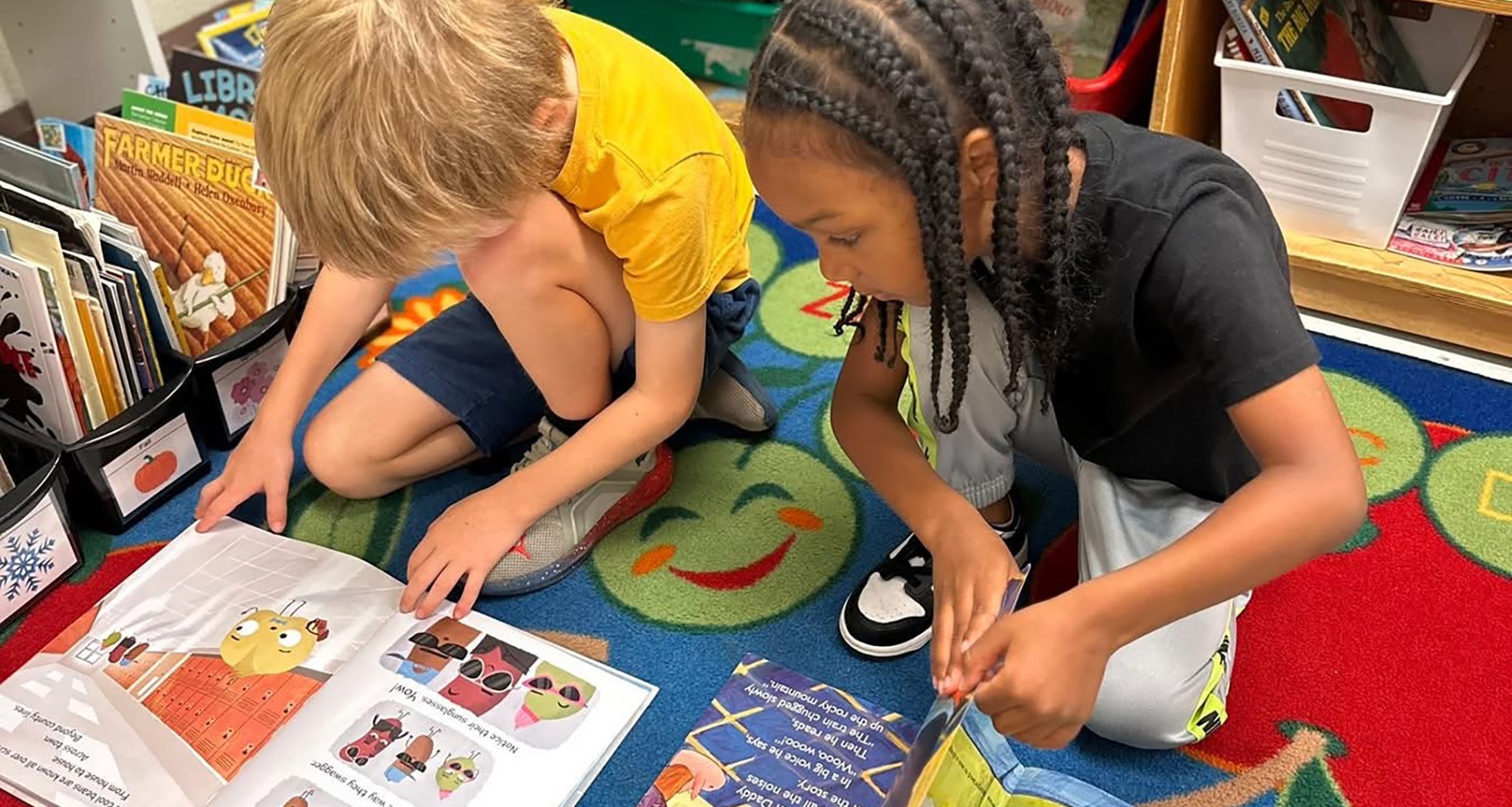 two students reading on the floor
