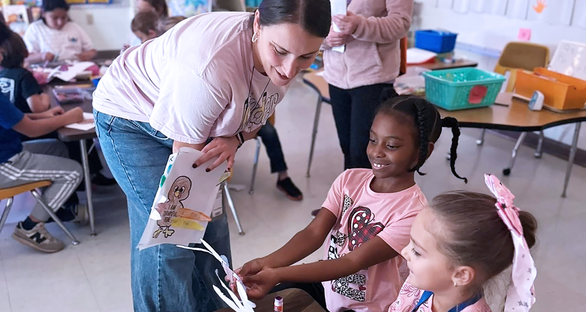 Teacher helping two students