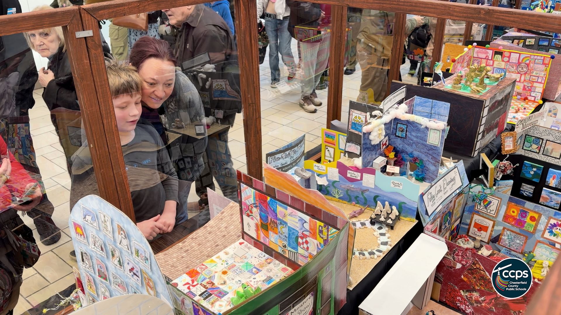 Families looking at exhibits in the Mini Museum