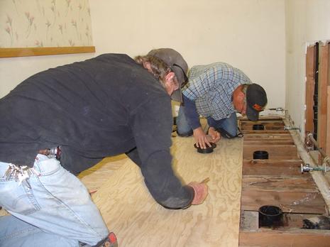 Brian Anders, Maintenance Worker and Todd Meese, Welder/Fabricator, Repairing Restroom Floor