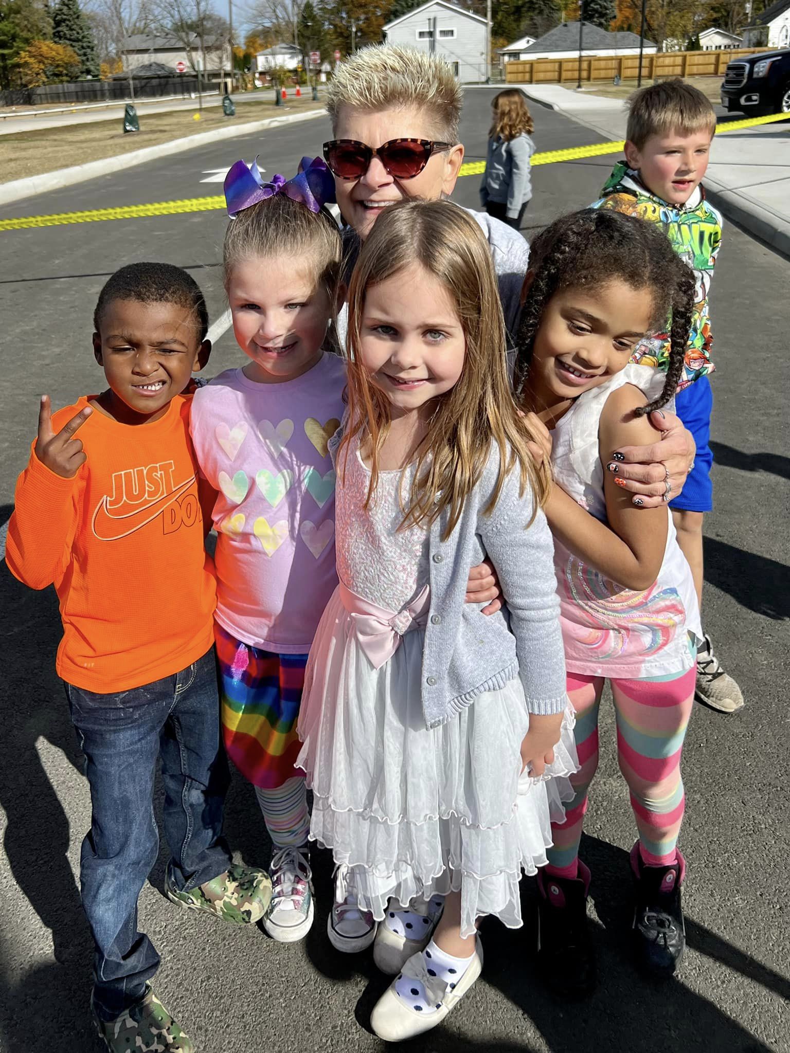 Superintendent hugging group of kids