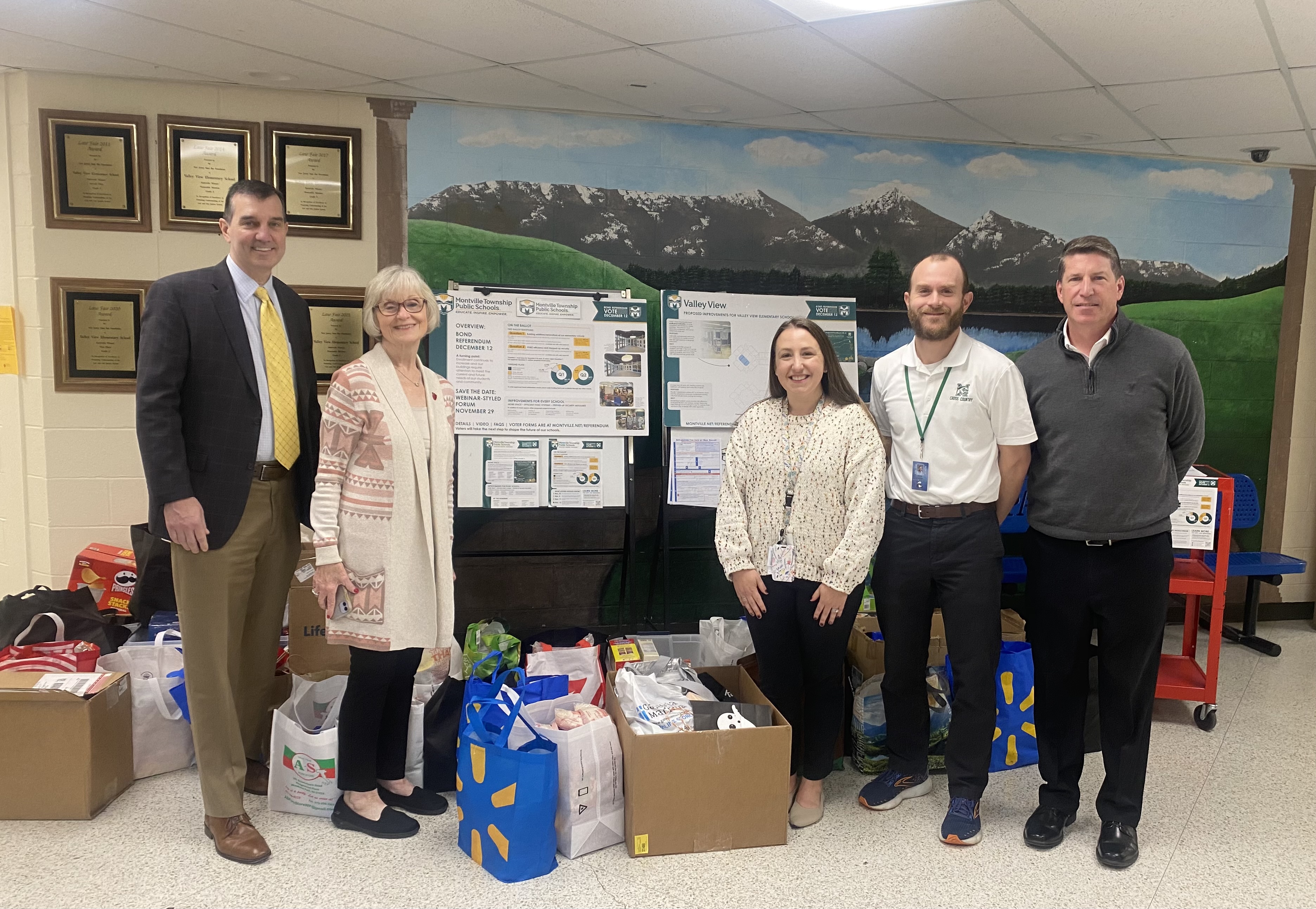 staff members with food drive items
