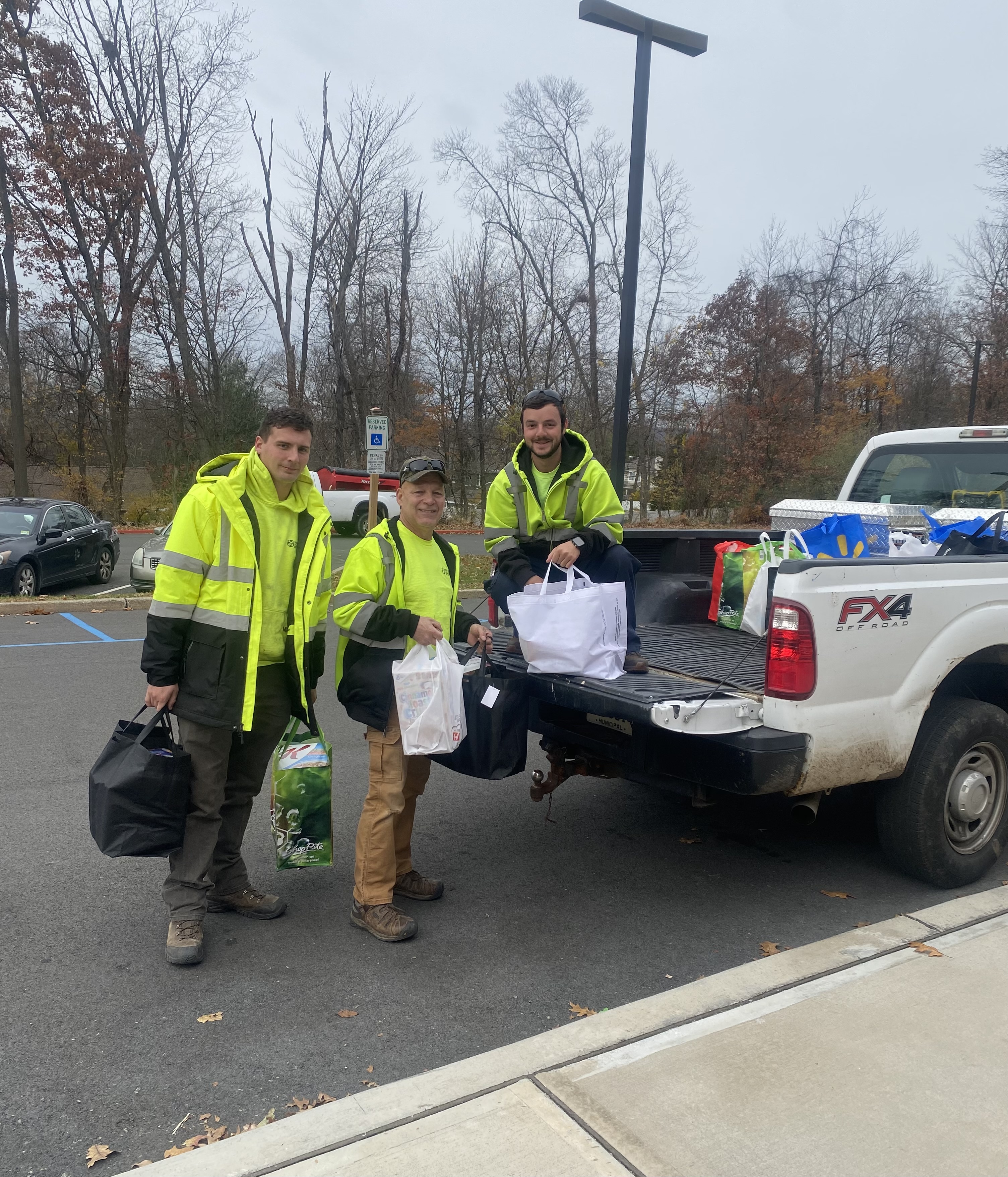 staff members with food drive items