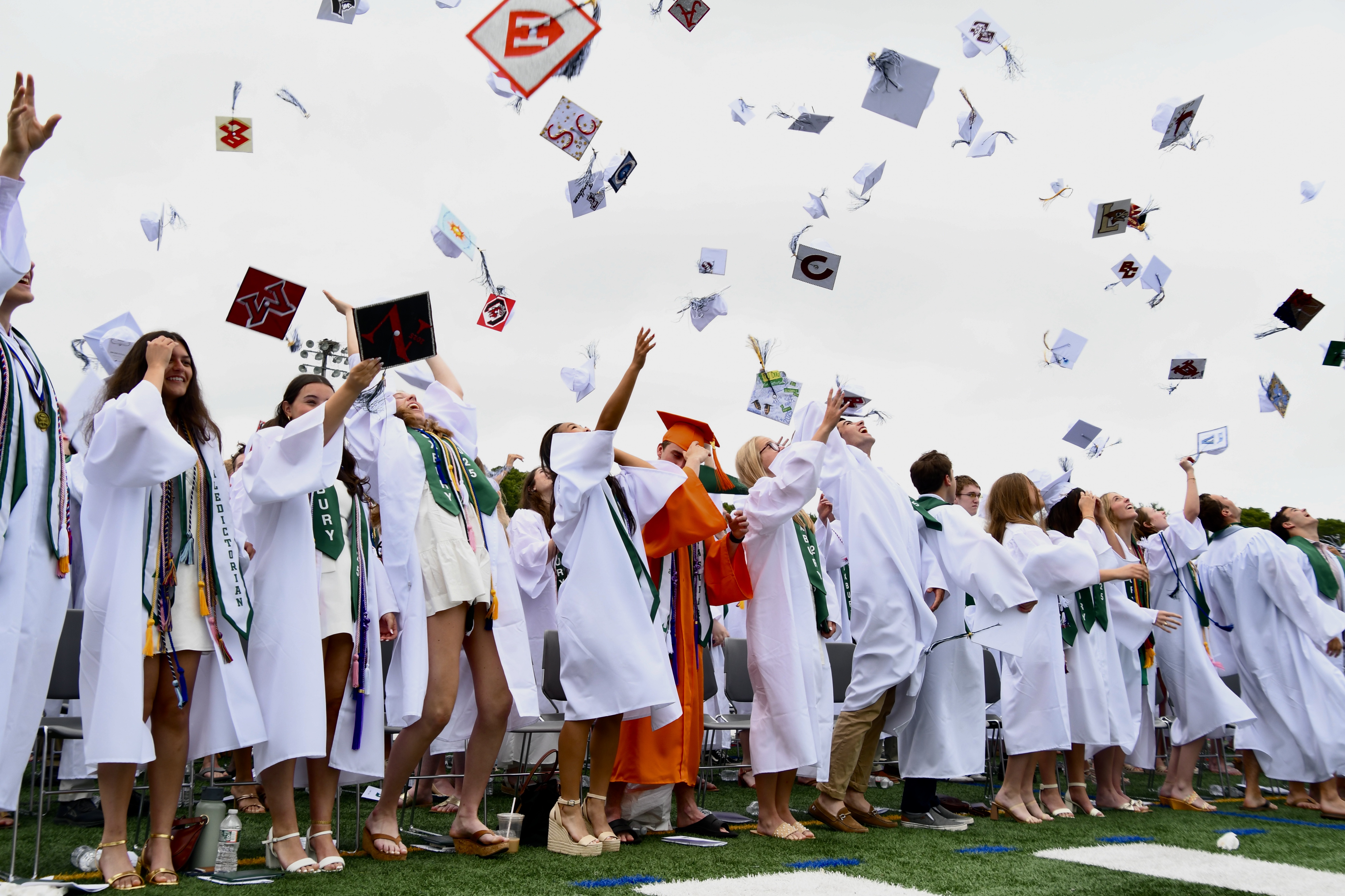 DHS graduates tossing caps in air