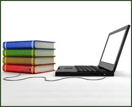 A photo of a computer and a stack of books