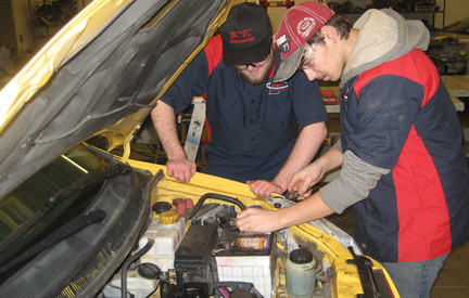 Students fixing a car