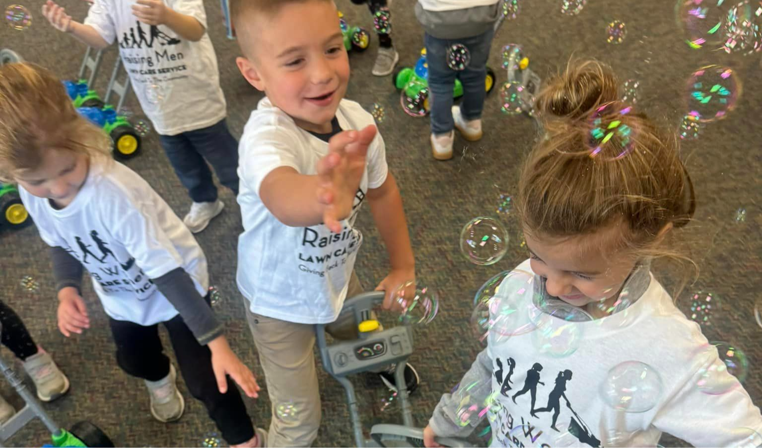 Preschoolers playing with bubble mowers