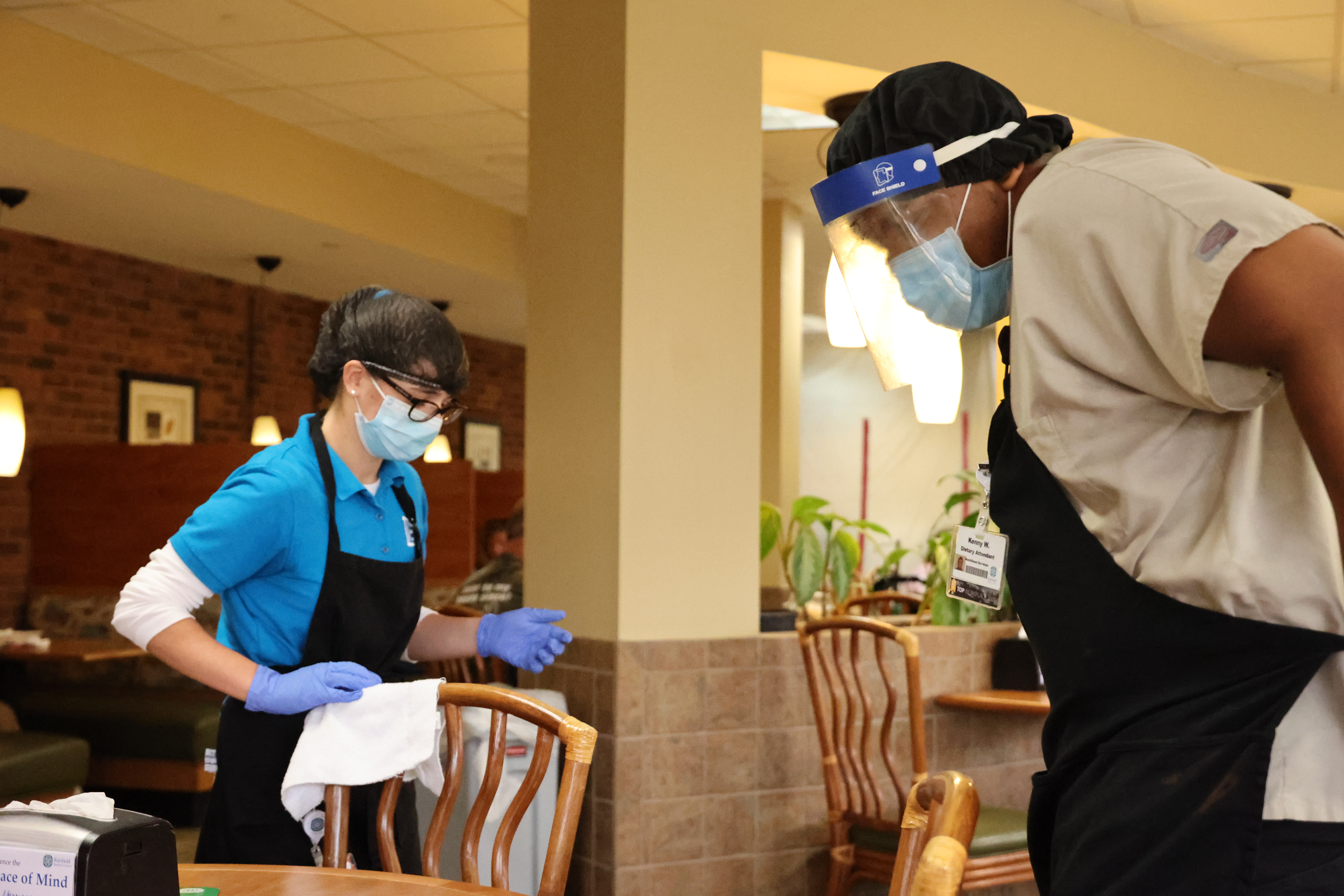 One current student and one alumnus of the Project SEARCH program work together to clean the FMC dining area.