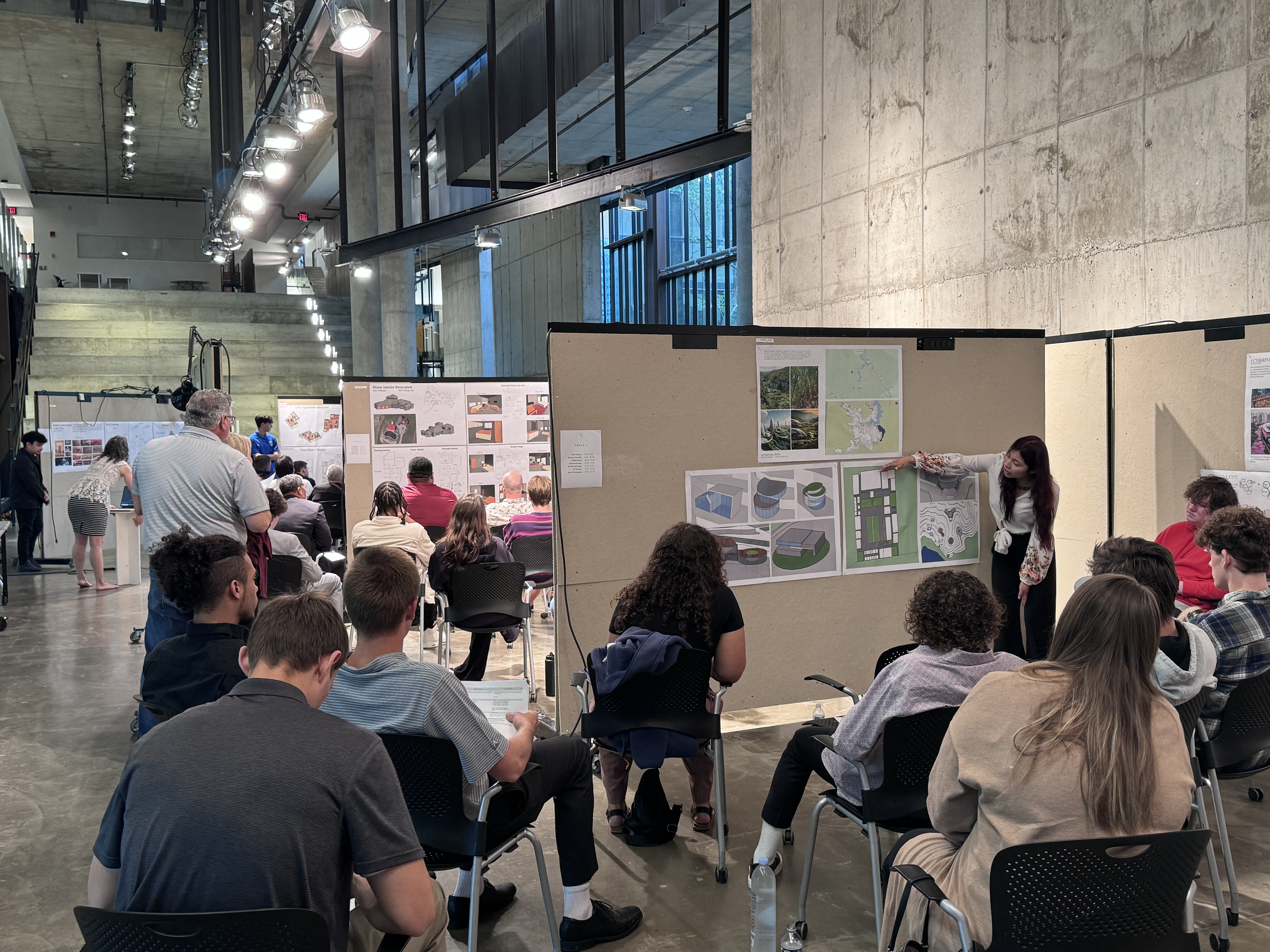 Wide angle shot of the three presentation areas students were delivering presentations from.