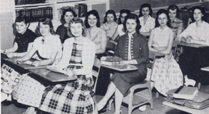 stydents smiling sitting in desk