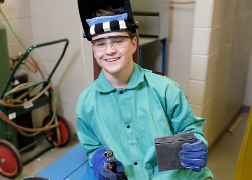 A student wearing welding safety gear