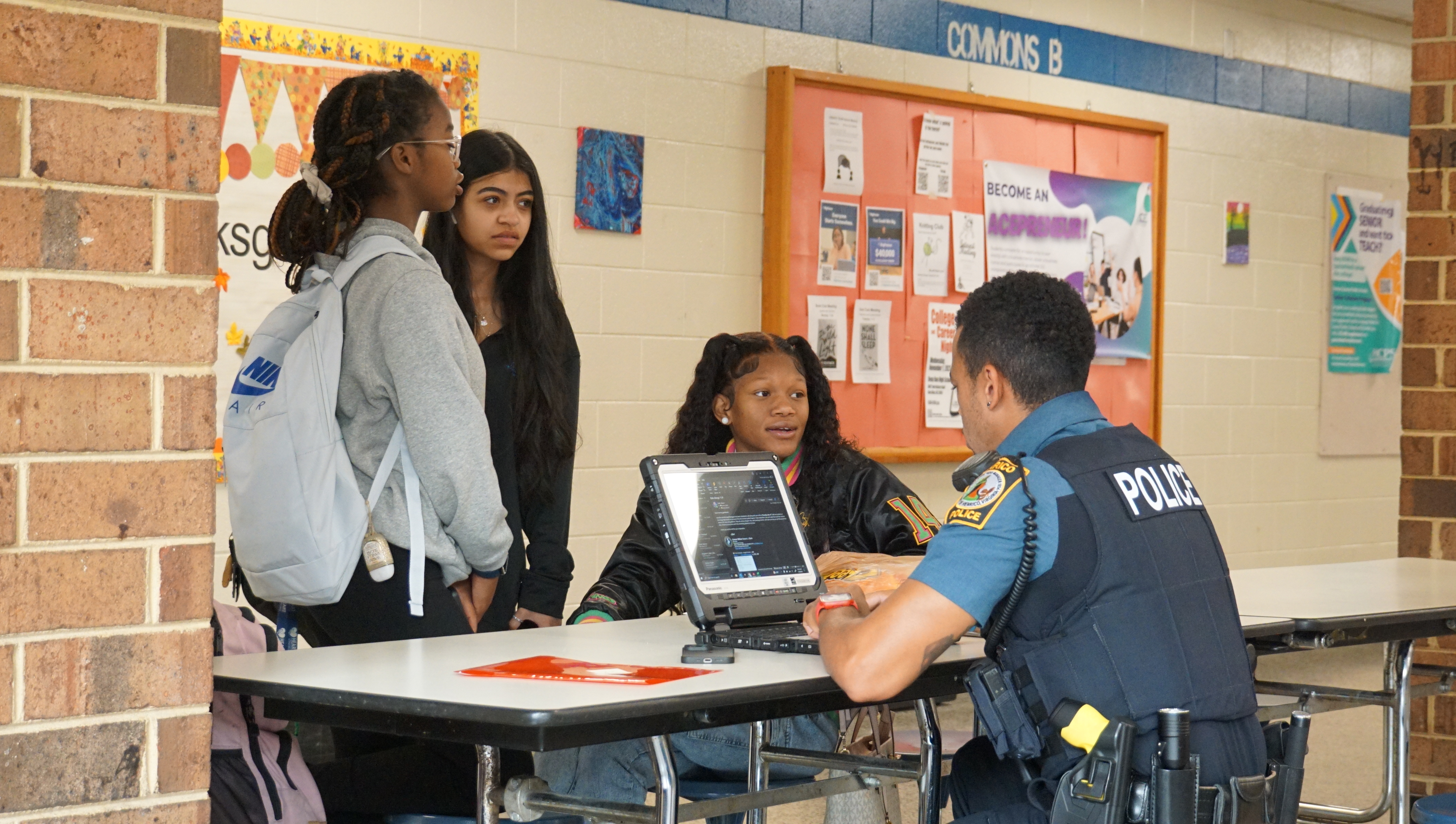 students talks with police officer
