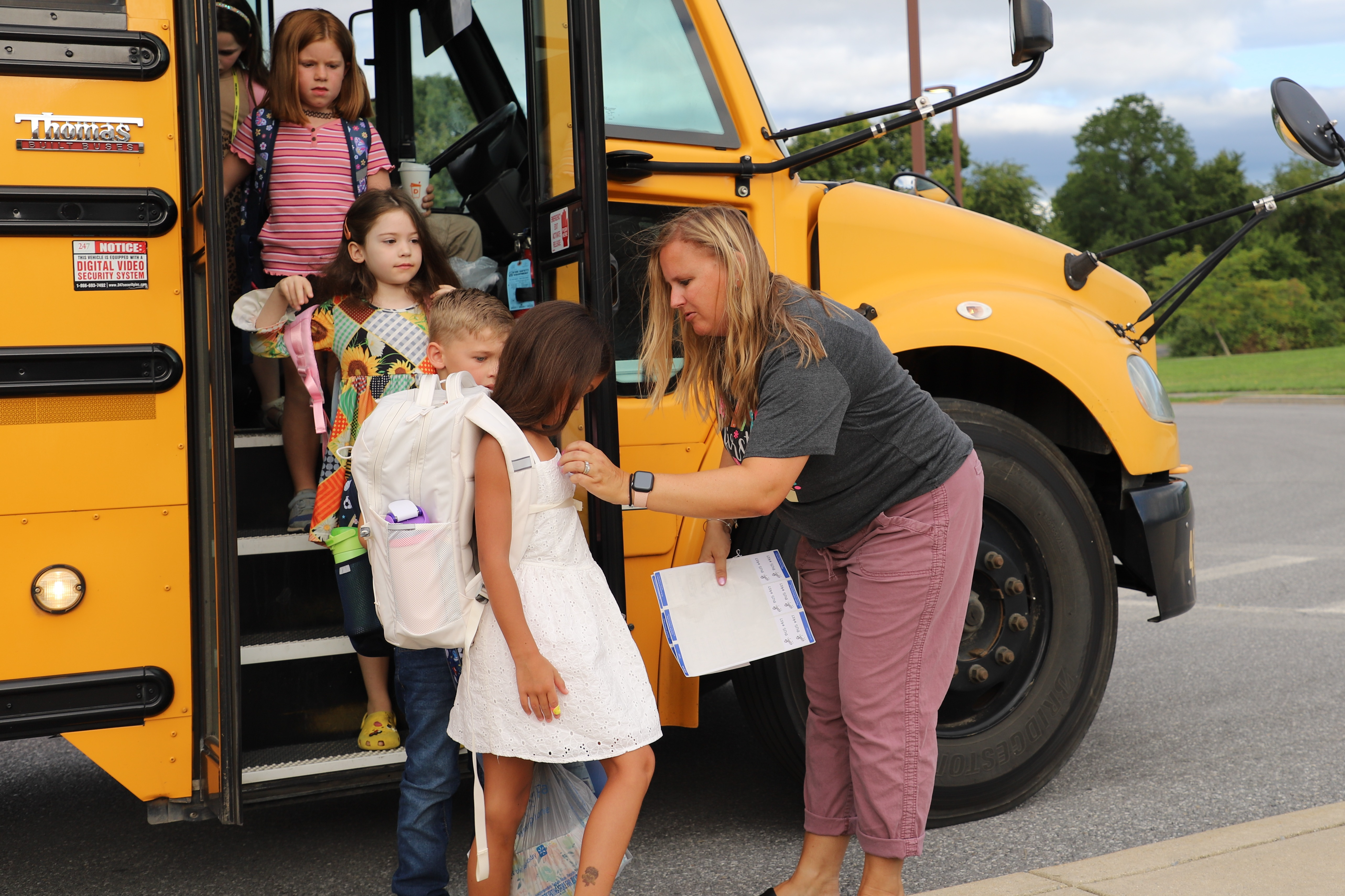 students getting off the bus