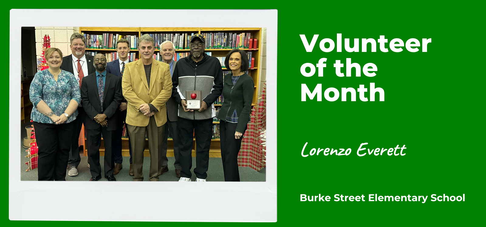 image of volunteer of the month recipient lorenzo everett standing with board members, superintendent, and principal