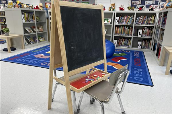 photo of chalkboard easel  and chair in the library