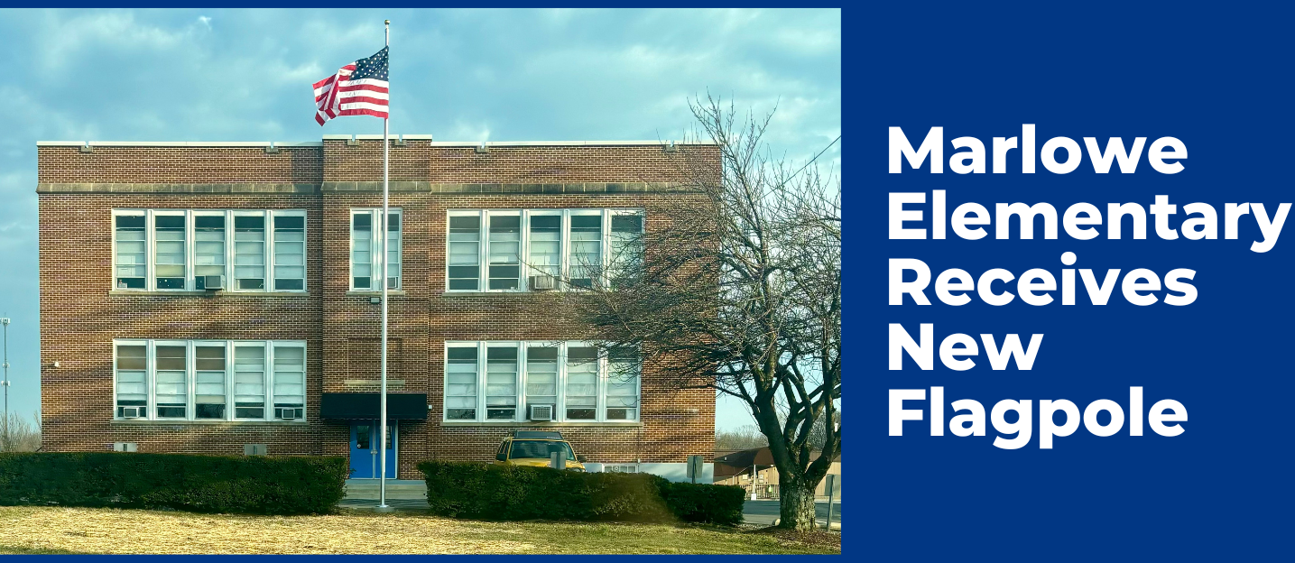 A photo of Marlowe Elementary Schoo, a 2-story brick building, with a new flagpole featuring a waving American flag.