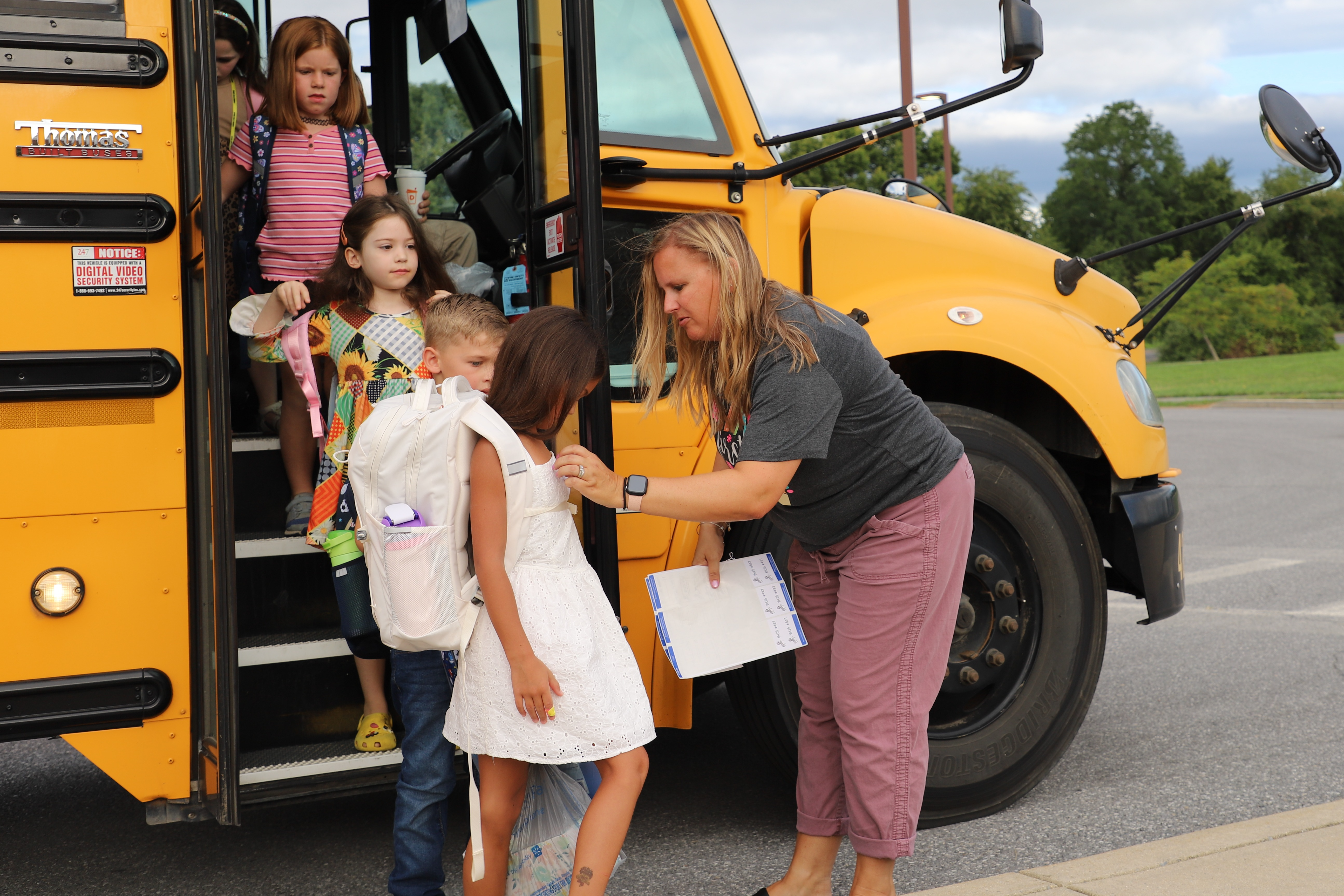 students getting off of a bus