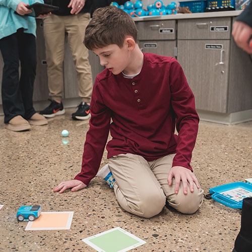 student learning with stem car