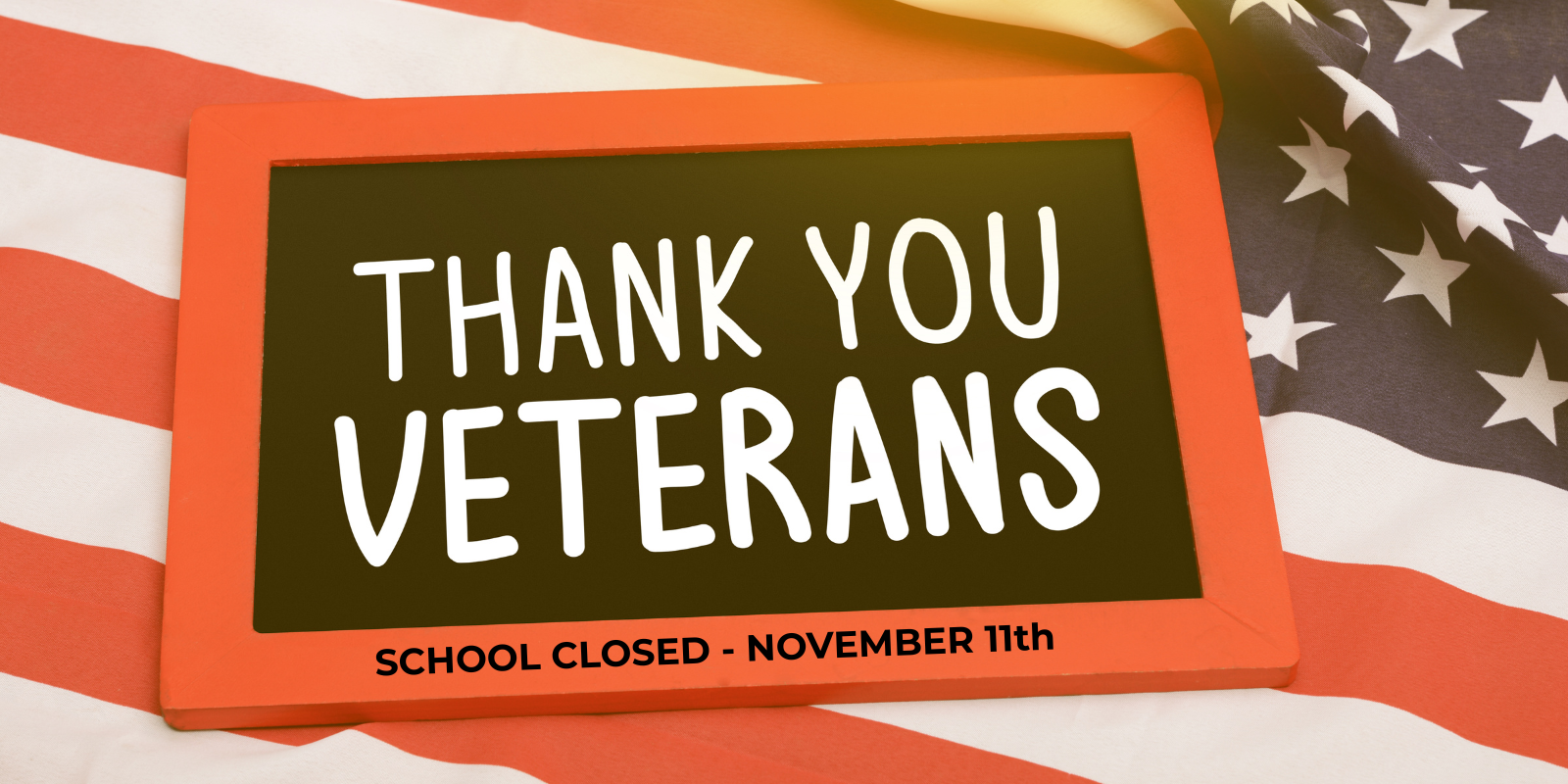 A sign that says "Thank you Veterans" on top of an American flag. Underneath it says "No School - November 11th."