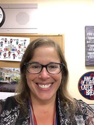 Headshot image of principal Stefankiewicz wearing black rimmed glasses